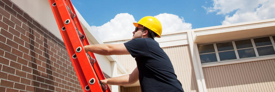 Roofer performing shingle repairs